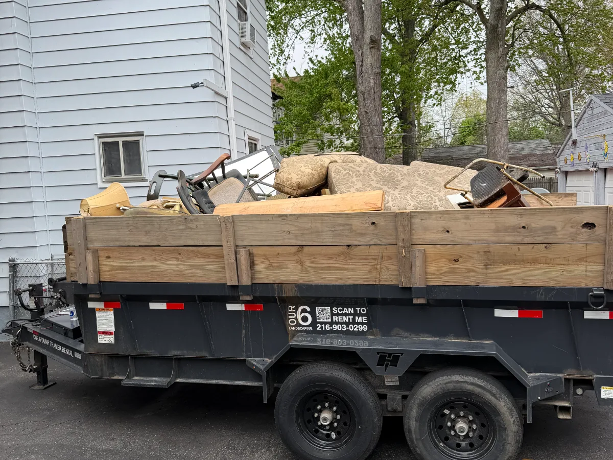 Dump trailer loaded during a furniture and junk removal job