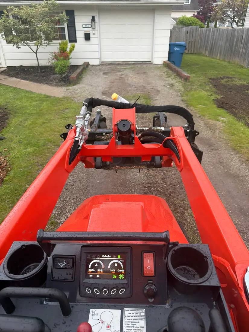 Machine spreading stone down the drive